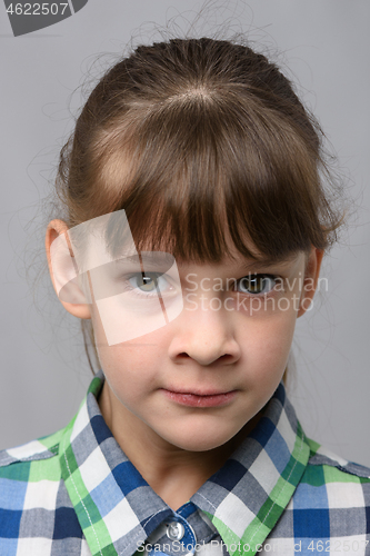 Image of Portrait of a nervous ten-year-old girl of European appearance, close-up