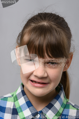 Image of Portrait of a ten-year-old girl who is disgusted from what she saw, European appearance, closeup