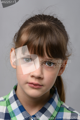 Image of Portrait of a perplexed ten-year-old girl of European appearance, close-up