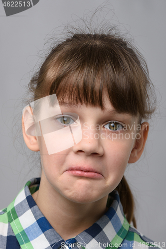 Image of Portrait of a surprised ten year old girl, European appearance, close-up