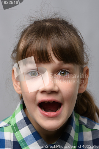 Image of Portrait of a genuinely surprised ten-year-old girl with closed eyes, European appearance, close-up