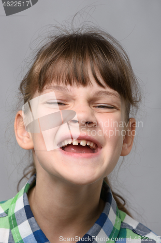 Image of Portrait of a joyfully smiling ten-year-old girl of European appearance, close-up