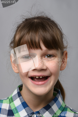 Image of Portrait of a funny ten-year-old girl with a cheerful smile, European appearance, close-up