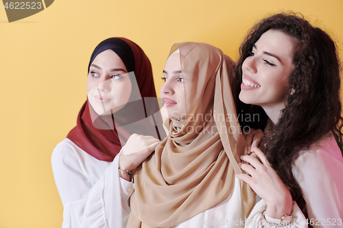 Image of muslim women in fashionable dress isolated on yellow