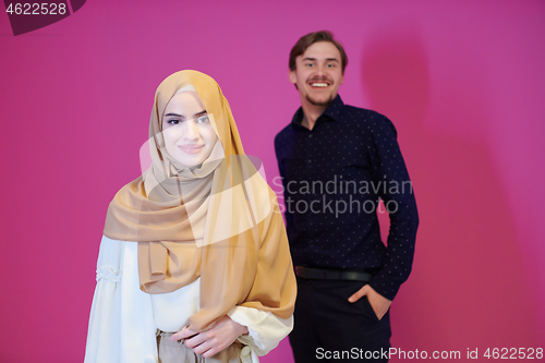 Image of portrait of young muslim couple isolated on pink background