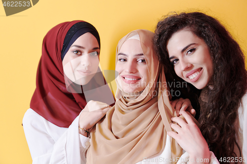 Image of muslim women in fashionable dress isolated on yellow