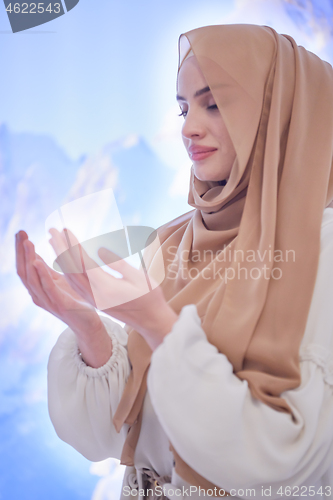 Image of beautiful muslim woman making traditional prayer to God