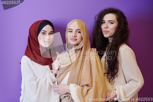 Image of muslim women in fashionable dress isolated on purple