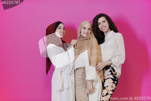 Image of muslim women in fashionable dress isolated on pink