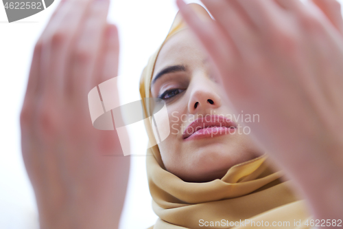 Image of muslim woman making traditional prayer to God