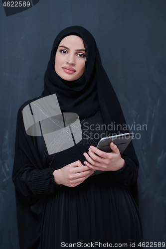 Image of young modern muslim business woman using tablet computer