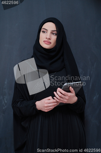 Image of young modern muslim business woman using tablet computer