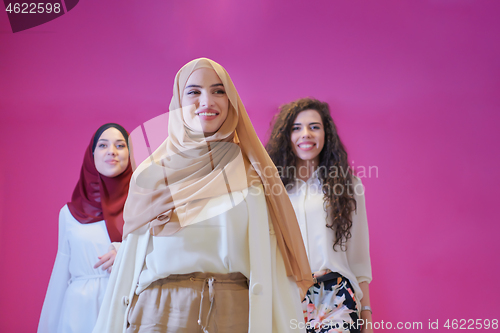 Image of muslim women in fashionable dress isolated on pink