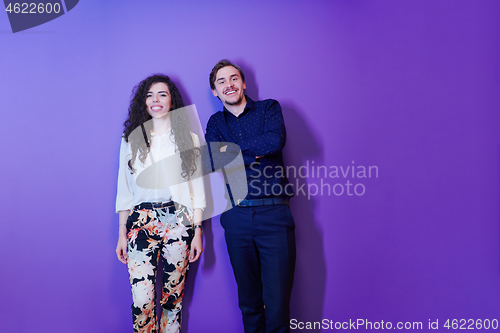 Image of portrait of young couple isolated over purple background