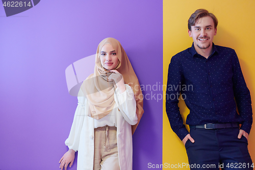 Image of portrait of young muslim couple isolated on colorful background