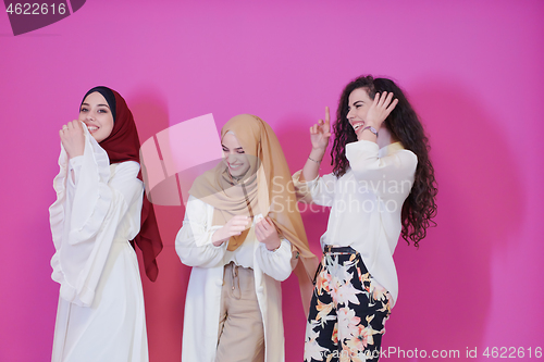 Image of muslim women in fashionable dress isolated on pink