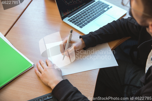 Image of Caucasian entrepreneur, businessman, manager working concentrated in office