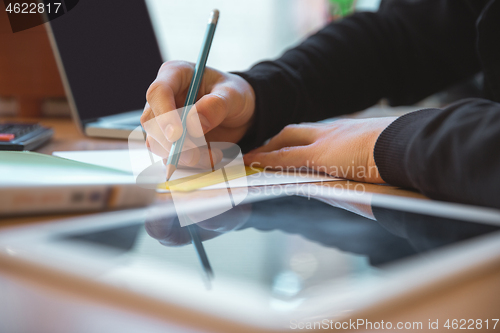 Image of Caucasian entrepreneur, businessman, manager working concentrated in office