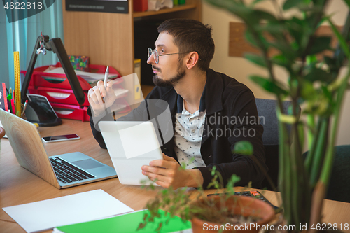 Image of Caucasian entrepreneur, businessman, manager working concentrated in office