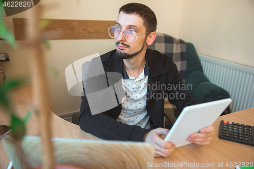 Image of Caucasian entrepreneur, businessman, manager working concentrated in office