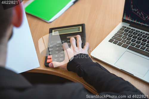 Image of Caucasian entrepreneur, businessman, manager working concentrated in office