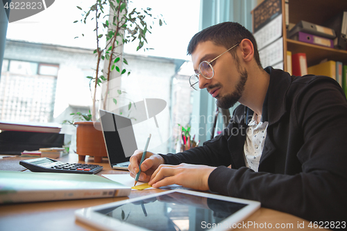 Image of Caucasian entrepreneur, businessman, manager working concentrated in office