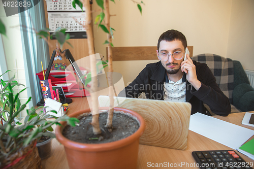 Image of Caucasian entrepreneur, businessman, manager working concentrated in office