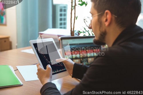 Image of Caucasian entrepreneur, businessman, manager working concentrated in office