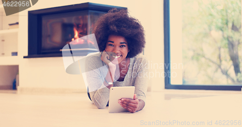 Image of black women using tablet computer on the floor