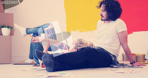 Image of Happy young couple relaxing after painting