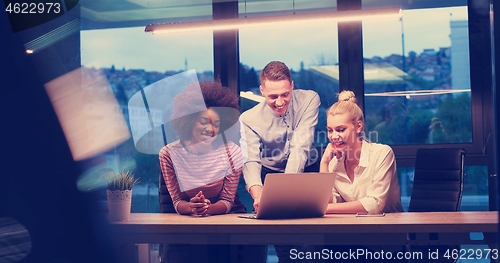 Image of Multiethnic startup business team in night office