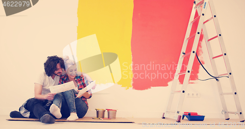 Image of Happy young couple relaxing after painting