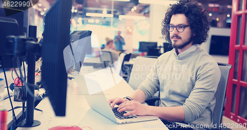 Image of businessman working using a laptop in startup office