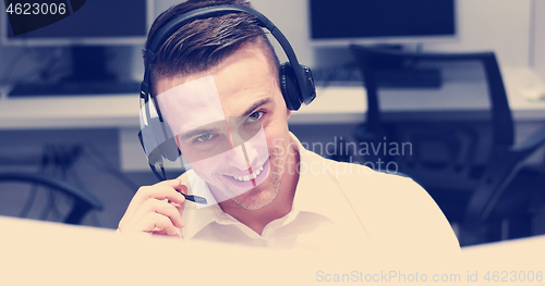 Image of male call centre operator doing his job