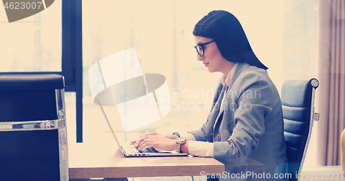 Image of businesswoman using a laptop in startup office