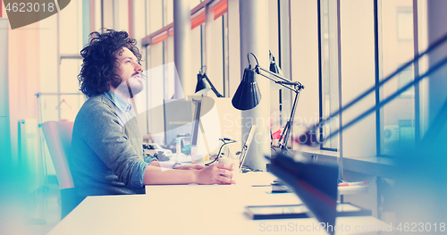 Image of businessman working using a laptop in startup office