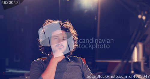 Image of man working on computer in dark office