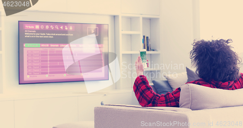 Image of Young couple on the sofa watching television