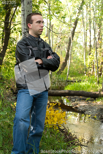 Image of Man Relaxing By A Stream