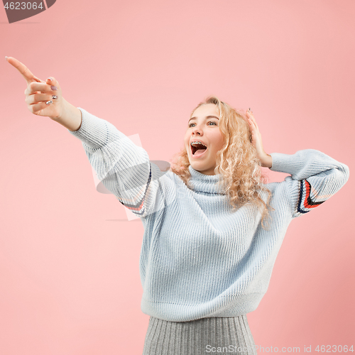 Image of Beautiful woman looking suprised isolated on pink