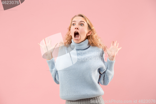 Image of Beautiful woman looking suprised isolated on pink