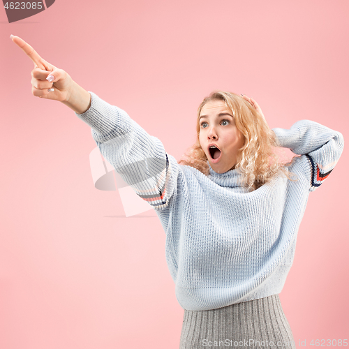 Image of Beautiful woman looking suprised isolated on pink