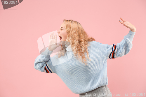 Image of Isolated on pink young casual woman shouting at studio