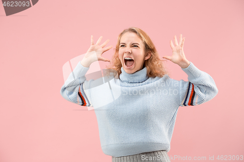 Image of Beautiful woman looking suprised isolated on pink