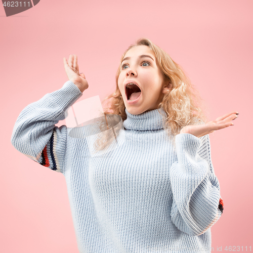 Image of Beautiful woman looking suprised isolated on pink