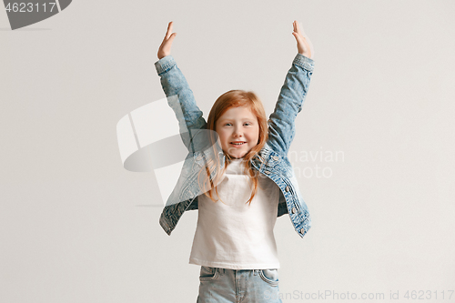 Image of Full length portrait of cute little kid in stylish jeans clothes looking at camera and smiling