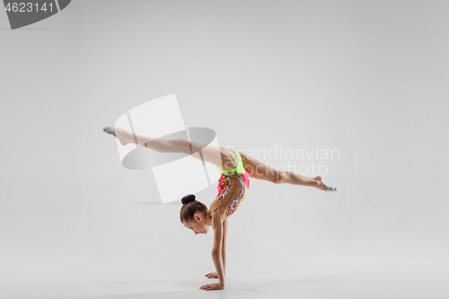 Image of The teenager girl doing gymnastics exercises isolated on white background