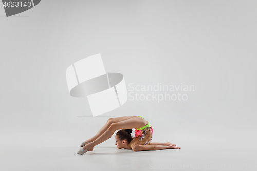 Image of The teenager girl doing gymnastics exercises isolated on white background