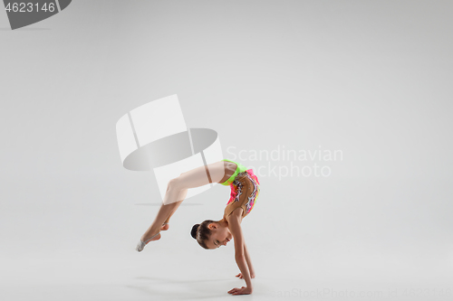 Image of The teenager girl doing gymnastics exercises isolated on white background