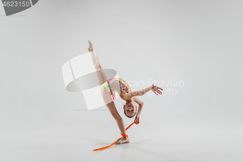 Image of The teenager girl doing gymnastics exercises isolated on white background